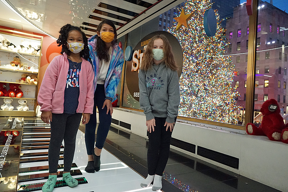 Three girls on the FAO Schwarz dance-on piano