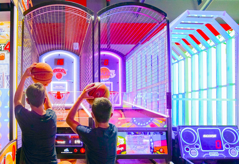 Photo of two kids at a basketball-themed arcade game in CT.