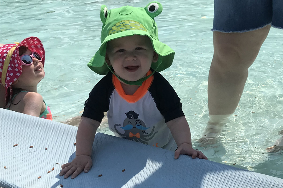a toddler in a kiddie pool