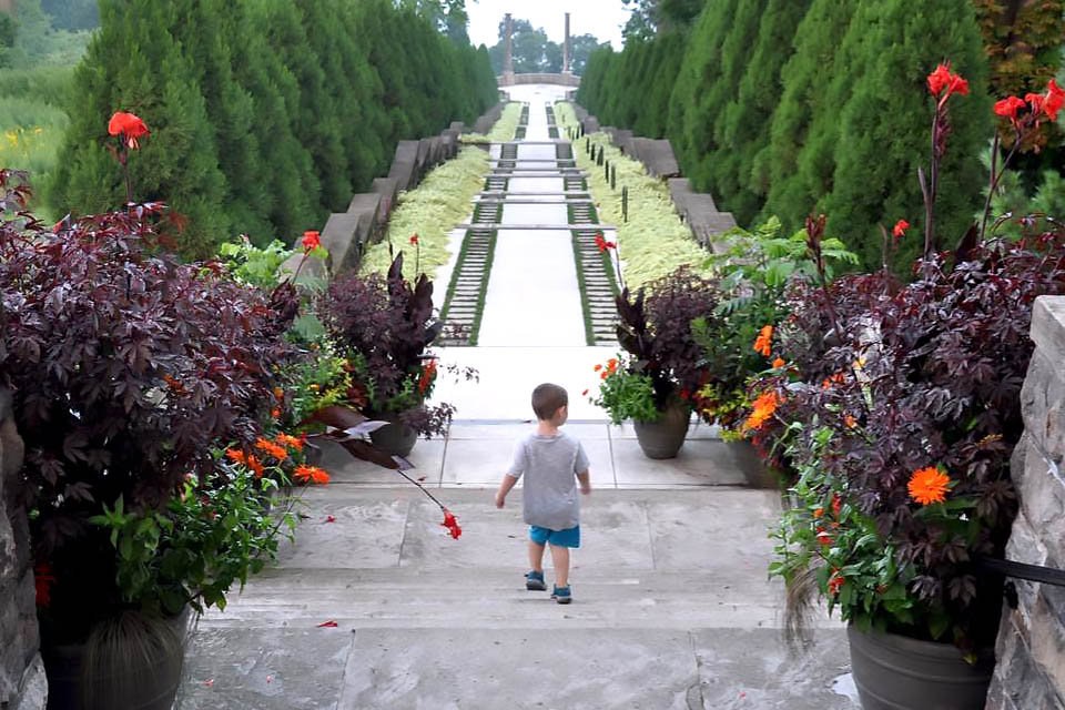 Boy walks through Untermyer Gardens where admission is free